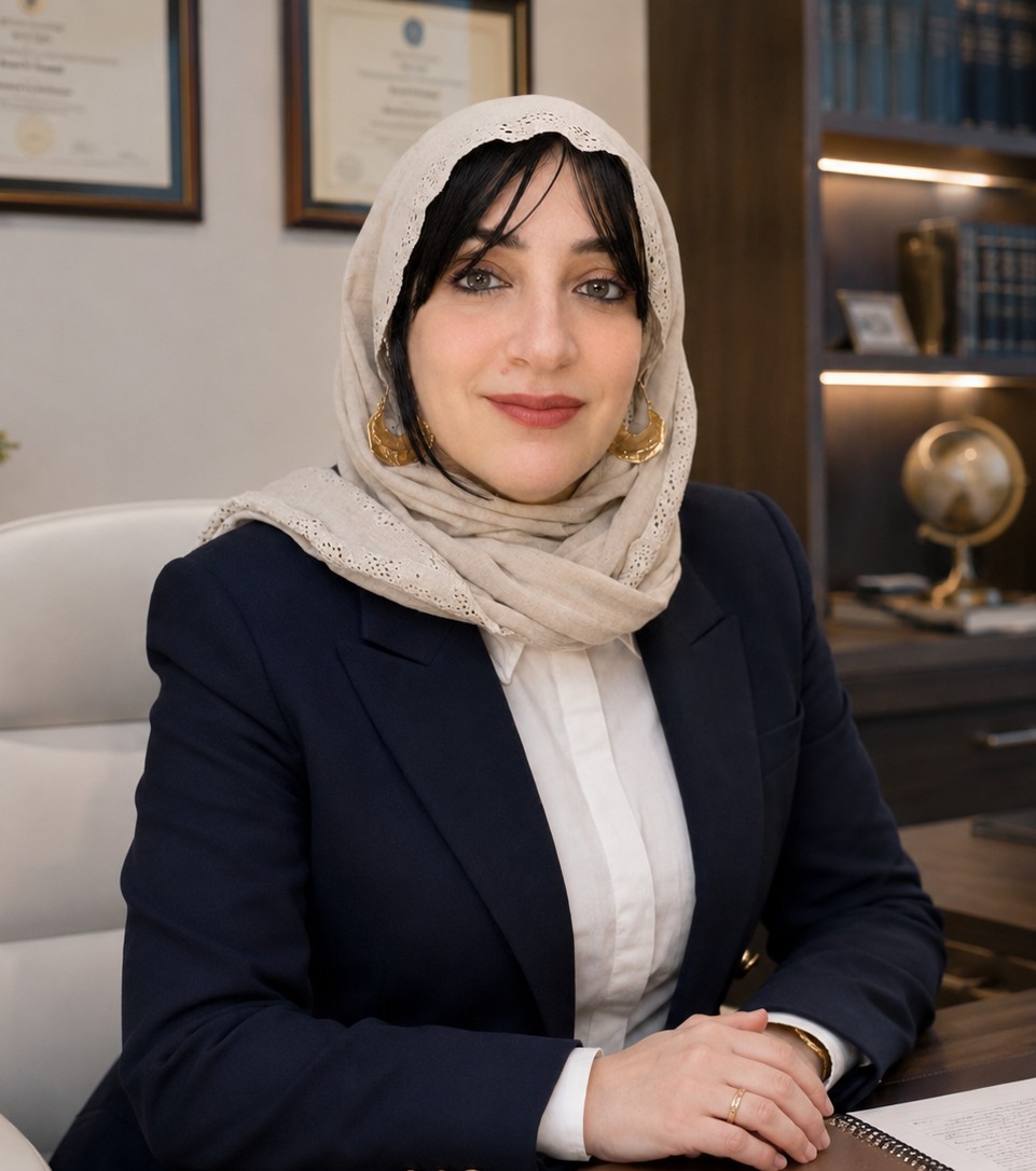 Dr. Abir Ahmed Aly Wafa at her desk, mid-session